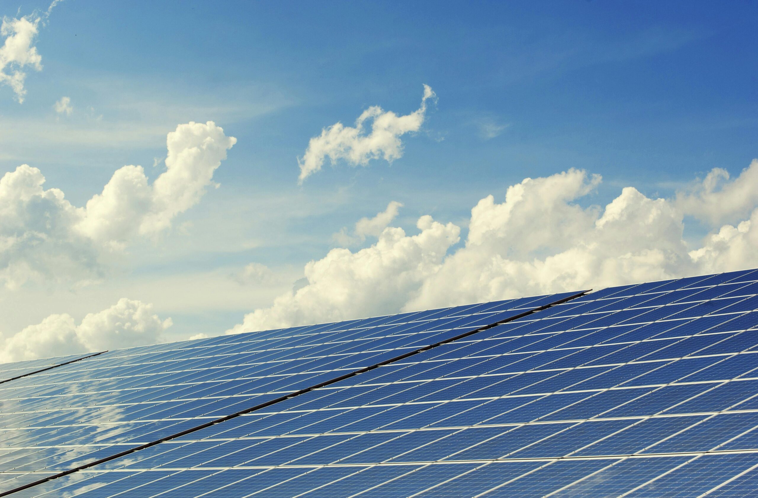 pexels-photo-356036-356036 | Architecture vastu maharishi Sleek modern solar panels under a vibrant blue sky with clouds, symbolizing clean energy.